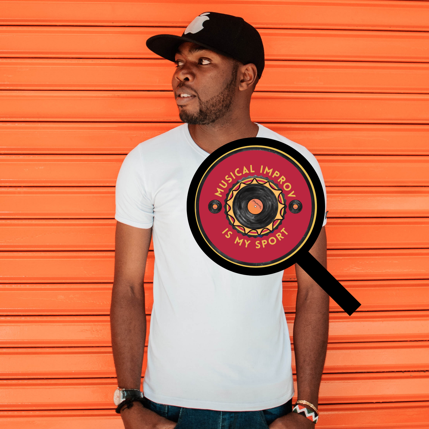magnifying glass showing the pinback button on a white shirt. vinyl record design with the text "Musical Improv Is My Sport" on a bold orange background. The pin's back is shown alongside, displaying its fastening mechanism.
