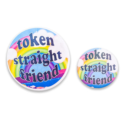 close-up view of big and small colorful 'Token Straight Friend' holographic pin featuring a bold rainbow design and playful text, perfect for pride events and allyship.
