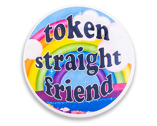 close-up view of a colorful 'Token Straight Friend' holographic pin featuring a bold rainbow design and playful text, perfect for pride events and allyship